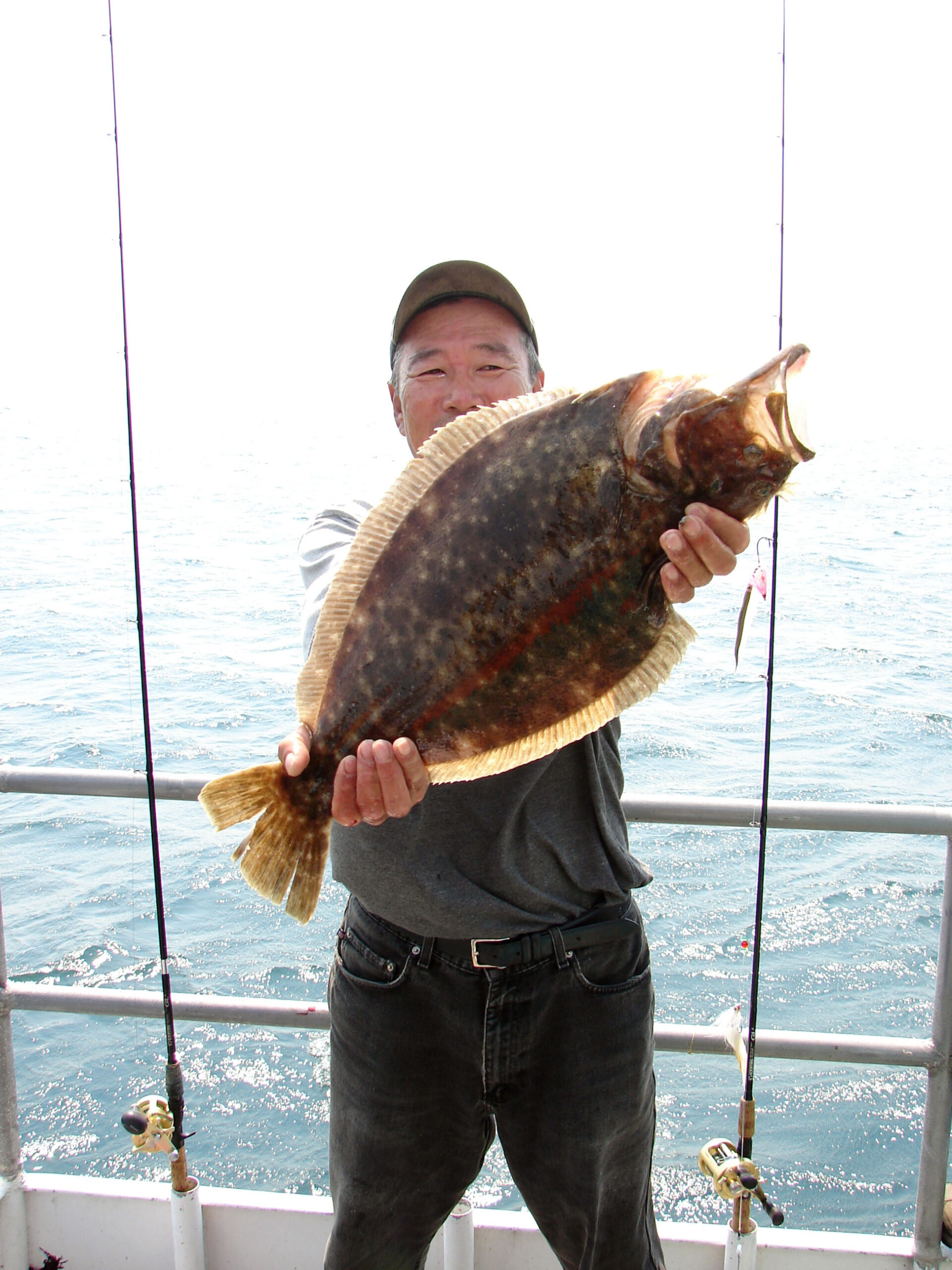 Angler holding large summer flounder
